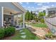 Backyard with patio, manicured lawn, mature trees, and rock water feature at 4207 N Carver Dr, Atlanta, GA 30360