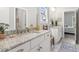 Elegant bathroom with granite countertops, dual sinks, and a view to the bedroom at 4207 N Carver Dr, Atlanta, GA 30360