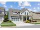 Well-maintained two-story home with a covered front porch, lush lawn and colorful landscaping at 4207 N Carver Dr, Atlanta, GA 30360