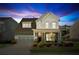 Inviting two-story home with a charming front porch, landscaped yard, and attached two car garage at 4207 N Carver Dr, Atlanta, GA 30360