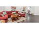 Open living room with hardwood floors and a comfortable red sectional at 4207 N Carver Dr, Atlanta, GA 30360