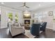 Inviting living room with a stone fireplace, comfortable seating, and French doors leading outside at 4207 N Carver Dr, Atlanta, GA 30360
