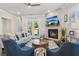 Cozy living room featuring a stone fireplace, comfortable seating, and access to outdoor space at 4207 N Carver Dr, Atlanta, GA 30360