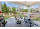 Covered patio with seating area overlooking lush backyard and water feature at 4207 N Carver Dr, Atlanta, GA 30360