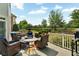 Outdoor living area featuring deck with comfortable seating and grill, overlooking backyard at 5335 Davenport Mnr, Cumming, GA 30041