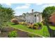 Manicured backyard with lush lawn, garden beds, and deck for outdoor enjoyment at 5335 Davenport Mnr, Cumming, GA 30041