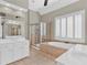 A luxurious bathroom with double sink vanity, tub and glass enclosed shower at 5335 Davenport Mnr, Cumming, GA 30041