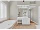 This bathroom has a soaking tub, a white double vanity, and a large mirror at 5335 Davenport Mnr, Cumming, GA 30041