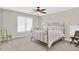 Bright bedroom with carpet, ceiling fan, and natural light at 5335 Davenport Mnr, Cumming, GA 30041