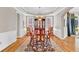 Formal dining room with hardwood floors, elegant chandelier, and classic wainscoting at 5335 Davenport Mnr, Cumming, GA 30041