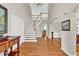 Elegant foyer with a curved staircase, hardwood floors, and soaring ceilings at 5335 Davenport Mnr, Cumming, GA 30041