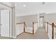 Bright hallway with carpet, wainscotting and white doors leads to other rooms at 5335 Davenport Mnr, Cumming, GA 30041