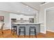Modern kitchen with white cabinetry, stainless steel appliances, and bar seating at 5335 Davenport Mnr, Cumming, GA 30041