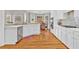 Open concept kitchen with stainless steel appliances, white cabinets and breakfast area at 5335 Davenport Mnr, Cumming, GA 30041