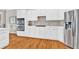 A kitchen with stainless steel appliances, white cabinets and hardwood flooring at 5335 Davenport Mnr, Cumming, GA 30041