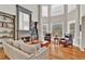 Cozy living room with a stone fireplace, built-in bookshelves, and plenty of seating at 5335 Davenport Mnr, Cumming, GA 30041