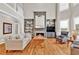 Spacious living room featuring a fireplace, built-in shelving, and hardwood flooring at 5335 Davenport Mnr, Cumming, GA 30041