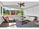 Bright sunroom with large windows, ceiling fan, and wicker furniture at 5335 Davenport Mnr, Cumming, GA 30041