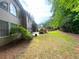 Landscaped backyard featuring beautiful trees and a well-maintained lawn at 6131 Windflower Dr, Powder Springs, GA 30127