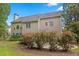 Exterior view of a well-maintained house and backyard surrounded by lush trees and landscaping at 6131 Windflower Dr, Powder Springs, GA 30127