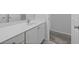 Bright bathroom featuring a white vanity with a large mirror and a neutral color scheme at 6131 Windflower Dr, Powder Springs, GA 30127