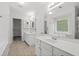Spacious bathroom featuring double sinks, a large mirror, and tiled floors at 6131 Windflower Dr, Powder Springs, GA 30127