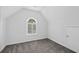 Small bedroom featuring an arched window and neutral carpet at 6131 Windflower Dr, Powder Springs, GA 30127