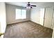 Comfortable bedroom with a ceiling fan, carpet, and double-door closet at 6131 Windflower Dr, Powder Springs, GA 30127