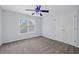 Comfortable bedroom featuring plush carpet, a ceiling fan and a window at 6131 Windflower Dr, Powder Springs, GA 30127