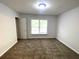 Cozy bedroom with carpet, a double-door closet, and a window for natural light at 6131 Windflower Dr, Powder Springs, GA 30127