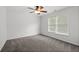 Cozy bedroom with neutral carpet, ceiling fan, and a bright window at 6131 Windflower Dr, Powder Springs, GA 30127