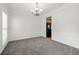 An empty dining room with elegant wainscoting and a chandelier at 6131 Windflower Dr, Powder Springs, GA 30127