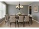 Elegant dining room with a stylish chandelier and seating for ten, perfect for entertaining at 6131 Windflower Dr, Powder Springs, GA 30127