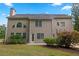 Two-story home with a neutral siding, chimney, and a patio outside the doors at 6131 Windflower Dr, Powder Springs, GA 30127