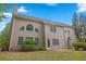 Two-story home with a neutral siding, chimney, and a patio outside the doors at 6131 Windflower Dr, Powder Springs, GA 30127