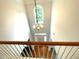 Bright foyer with hardwood floors, chandelier, and arched window bringing in lots of light at 6131 Windflower Dr, Powder Springs, GA 30127