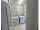 Functional laundry room with washer, dryer, and shelving at 6131 Windflower Dr, Powder Springs, GA 30127