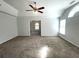 Bright living room with a ceiling fan and large windows offers comfortable living space at 6131 Windflower Dr, Powder Springs, GA 30127
