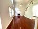 Living room with a fireplace, hardwood floors, and large windows offering plenty of natural light at 6131 Windflower Dr, Powder Springs, GA 30127