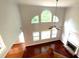 Spacious living room featuring a fireplace, hardwood floors, vaulted ceiling, and lots of windows at 6131 Windflower Dr, Powder Springs, GA 30127
