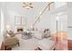 Bright living room featuring high ceilings, a cozy fireplace, and an elegant staircase leading to the upper level at 6131 Windflower Dr, Powder Springs, GA 30127