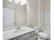 Bright bathroom with a single sink vanity, white toilet, and tub-shower combo at 1215 Elowen Dr, Austell, GA 30168