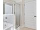 Modern bathroom with a glass-enclosed shower, white tiling, and fixtures at 1215 Elowen Dr, Austell, GA 30168