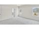 Spacious bedroom with plush carpeting, natural light from two windows and an open doorway at 1215 Elowen Dr, Austell, GA 30168