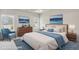 Staged bedroom featuring a plush bed, wood furniture, and lots of natural light at 1215 Elowen Dr, Austell, GA 30168