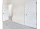 Bright bedroom with a neutral color scheme, plush carpeting, and white doors at 1215 Elowen Dr, Austell, GA 30168
