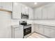 Well-lit kitchen with stainless steel appliances and white cabinets, with light countertops at 1215 Elowen Dr, Austell, GA 30168