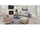 Staged living room showcasing a cozy fireplace, plush seating, and a stylish area rug at 1215 Elowen Dr, Austell, GA 30168