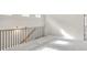 Spacious loft area with plush carpeting, natural light, and a decorative railing at 1215 Elowen Dr, Austell, GA 30168