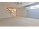 Finished basement with stairs, neutral carpet, lighting, and a large window at 389 Mill Creek Ne Bnd, Atlanta, GA 30307